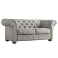 Causeuse Chesterfield à accoudoirs arrondis et capitonnée