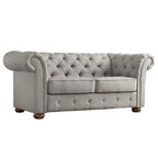 Causeuse Chesterfield à accoudoirs arrondis et capitonnée