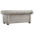 Causeuse Chesterfield à accoudoirs arrondis et capitonnée