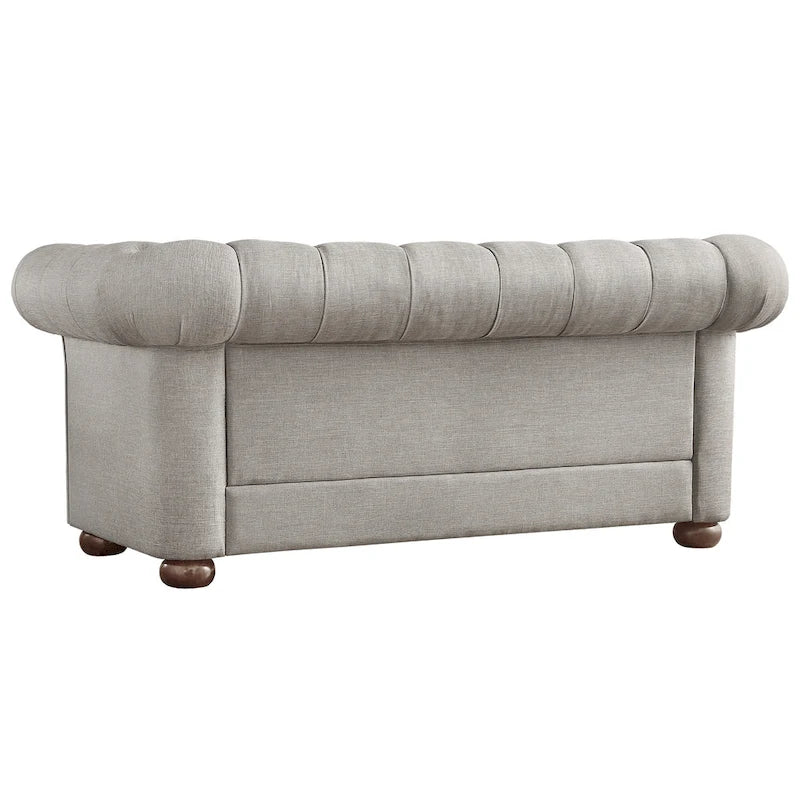 Causeuse Chesterfield à accoudoirs arrondis et capitonnée