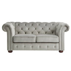 Causeuse Chesterfield à accoudoirs arrondis et capitonnée