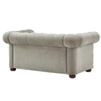 Causeuse Chesterfield à accoudoirs arrondis et capitonnée