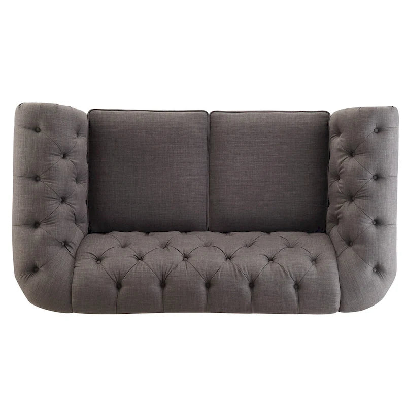 Causeuse Chesterfield à accoudoirs arrondis et capitonnée